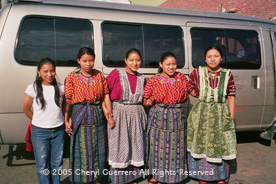 Many schoolgirls in Almolonga-like these high school students--still wear traje, though jeans and teeshirts are also in view.  Lidia Sanchez (right) wears a Patzún-style, while two of her sisters wear a recently popular style handwoven in Almolonga. Photo by Cheryl Guerrero 2005.