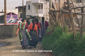 The traje in the department of Quetzaltenango includes an apron, often with lace edges, a jaspe or ikat skirt, and a hand woven huipil in a style specific to the community.  Photo by Cheryl Guerrero 2005.