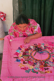 The rural areas around San Andrés Xecul are know for the women's imaginative embroidery, often with colorful animals. Here Vicenta Lucia Hernandes Paxtor works on her Easter huipil. Photo by Cheryl Guerrero 2005.