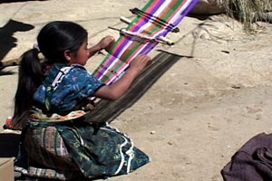 María Eugenia Lopez, 9, proudly worked on her second weaving sampler in the family compound.  Photo by Kathleen Mossman Vitale 2005.