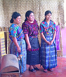 The Museo del Tejido in Antigua offers displays of traje from around the highlands. Esperanza Lopez (left) wove the huipil worn by Delmy Aramilda Sotz Lopez (right).  Aida Maritza Lopez models a new huipil, corte and belt from Chichicastenango.  Photo by Beth Riley 2005.