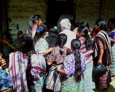 Videotaping weavers in indigenous communities is both a joy and a challenge.  In San Juan Cotzal local weavers excitedly crowd around to peek at the viewfinder when the camera is focused on the weaver's hands.  Photo by Paul G. Vitale 2005.