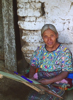 Inez Perez, a widow from the 36-year civil war, wears a huipil or blouse in a style common in San Juan Cotzal.  She wove her huipil on a back strap loom.  Photo by Paul G. Vitale 2005.