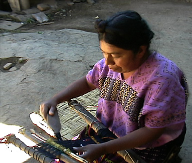 Nahualá weaver Juana Lopez straightens out the warps on her daughters weaving sample.  Photo by Kathleen Mossman Vitale 2005.