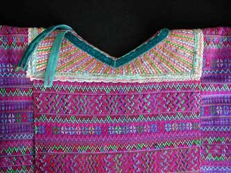 A huipil from the cooperative Estrella de Occidente store shows the heavily decorated weaving style of Todos Santos.  Collars can be purchased separately, and are reused after a huipil wears out.  Photo by Kathleen Mossman Vitale 2005.