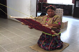 Emilia Chay Poz weaves a servilleta or multipurpose cloth on her back strap loom at the Santa Ana weaving cooperative in Zunil.  Photo by Kathleen Mossman Vitale 2005.