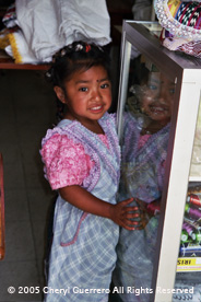 Small children of workers at the Guipil de Nebáj workshop are allowed by owner Julian Ulin to be nearby under the group's watchful eyes, solving the child care problems of young workers.  Photo by Cheryl Guerrero 2005.