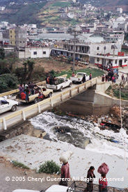 On market day trucks from outlying areas line up for miles to get into the tight cobblestone streets of Zunil and unload their produce.  Photo by Cheryl Guerrero 2005.