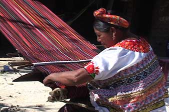 Andrea Raymundo, who lives in the aldea or rural community of Leana Cayote near Aguacatan, weaves a corte or skirt length in her front yard. Here Maya women, prefer their own design, and do not wear the jaspe or ikat skirts popular in many other areas of Guatemala. Photo by Kathleen Mossman Vitale 2005.