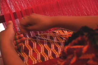 Lidia Sanchez, 16, weaves a huipil panel on a back strap loom in the currently popular style of Almolongo.  Photo by Kathleen Mossman Vitale 2005.