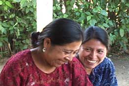 Weaver Josefina Xoná Gualím, Baleu, and Rosalía Asig, an outreach worker for the local coffee pickers' association, enjoy chatting.  Photo by Kathleen Mossman Vitale 2005.