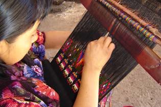 Manuela Canil Ren, Chichicastenango, works on a geometric floral pattern above a row of quetzal birds on a sleeve panel for a huipil.  Photo by Denise Gallinetti 2005.