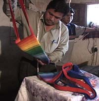 Clemente Ruiz Salanic, a Kaqchikel-speaking Mayan Hands Field Supervisor, checks in bags crocheted by members of a women's group in El Adelanto.  Photo by Kathleen Mossman Vitale 2005.