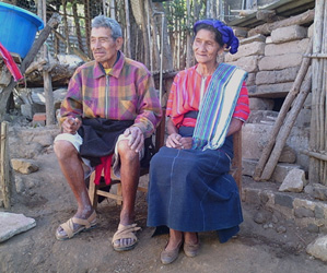 Maguey expert Lucas Patzún Mendosa, 74, and his wife Lucia Sache, 69, a back strap loom weaver, sit in the garden of their compound high on a mountain slope in San Marcos La Laguna.  Photo by Kathleen Mossman Vitale 2005.