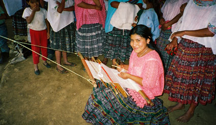 María Elena Xol Ae also weaves in the pikb'il style. The huipil or blouse she wears, however, is machine made and purchased in a market. Her corte or skirt is jaspe or ikat, where the threads are tied and dyed prior to weaving. Photo by Margot Blum Schevill. María Elena Xol Ae also weaves in the pikb'il style. The huipil or blouse she wears, however, is machine made and purchased in a market. Her corte or skirt is jaspe or ikat, where the threads are tied and dyed prior to weaving. Photo by Margot Blum Schevill 2005.